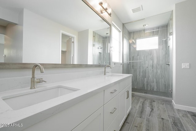 1571 E Tiffany Way, Gilbert, AZ 85298 - full bathroom featuring a stall shower, double vanity, wood finished floors, and baseboards