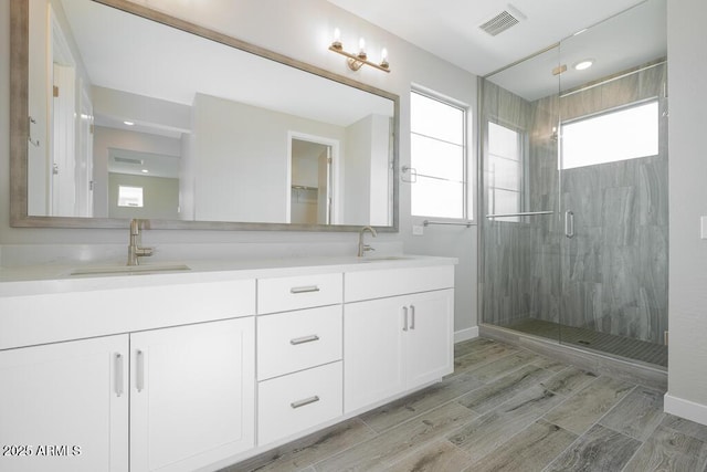 1571 E Tiffany Way, Gilbert, AZ 85298 - bathroom with double vanity, a stall shower, wood finish floors, baseboards, and recessed lighting