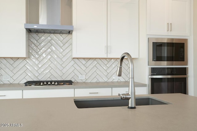 1571 E Tiffany Way, Gilbert, AZ 85298 - kitchen featuring wall chimney exhaust hood, stainless steel oven, built in microwave, a sink, and white cabinets