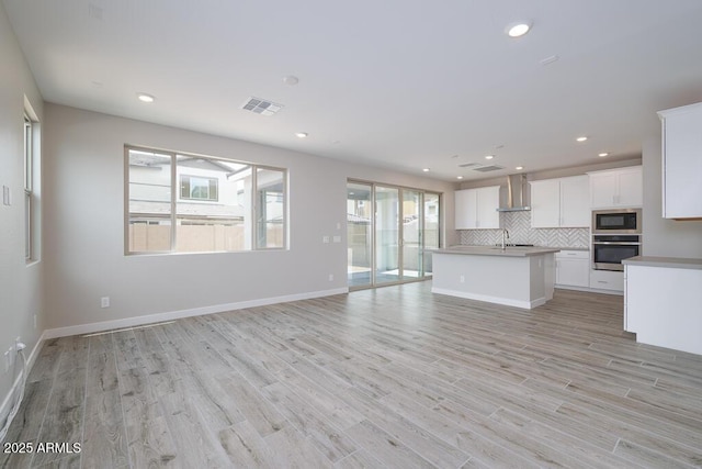 1571 E Tiffany Way, Gilbert, AZ 85298 - unfurnished living room with a sink, recessed lighting, light wood-type flooring, and baseboards
