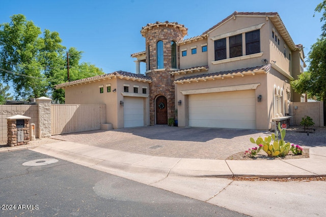 mediterranean / spanish home featuring a garage