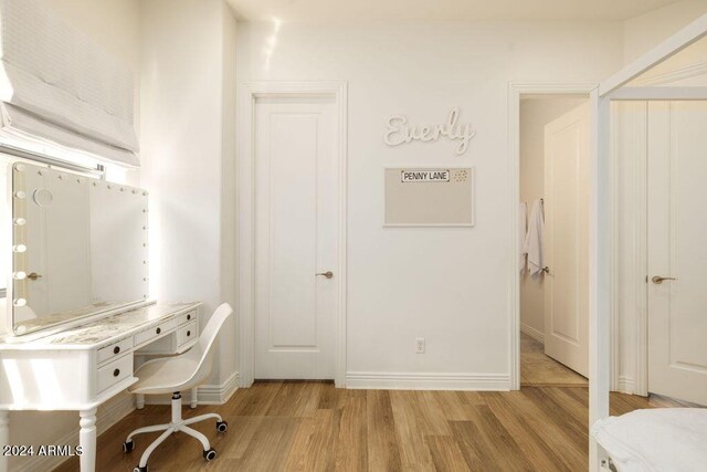 hall featuring wood-type flooring and a healthy amount of sunlight