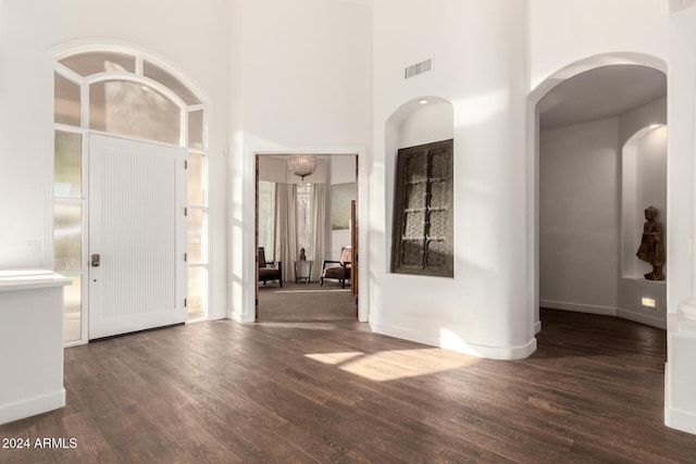 foyer featuring dark hardwood / wood-style floors and a high ceiling