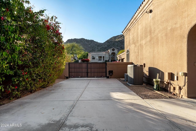 view of patio with a mountain view and central AC