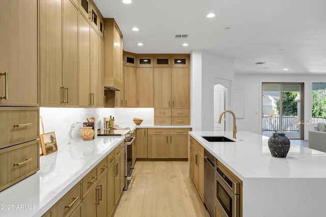 2774 E Valencia St, Gilbert, AZ 85296 - kitchen with a sink, appliances with stainless steel finishes, light wood finished floors, recessed lighting, and a center island with sink