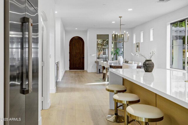 2774 E Valencia St, Gilbert, AZ 85296 - kitchen with high quality fridge, recessed lighting, a kitchen bar, light wood-style floors, and a chandelier