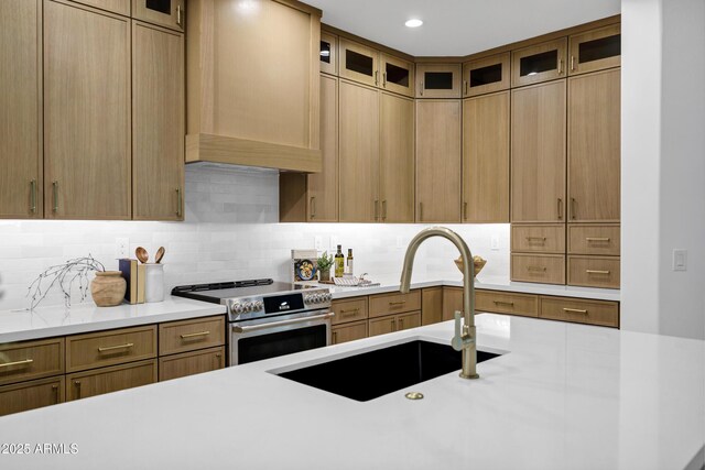 2774 E Valencia St, Gilbert, AZ 85296 - kitchen with stainless steel electric range oven, a sink, ventilation hood, light countertops, and backsplash