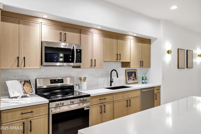 2774 E Valencia St, Gilbert, AZ 85296 - kitchen with stainless steel appliances, a sink, light countertops, decorative backsplash, and light brown cabinetry