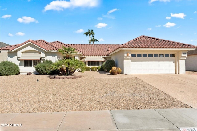 mediterranean / spanish-style home with a garage