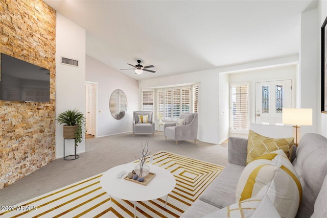 living room featuring vaulted ceiling, carpet floors, and ceiling fan