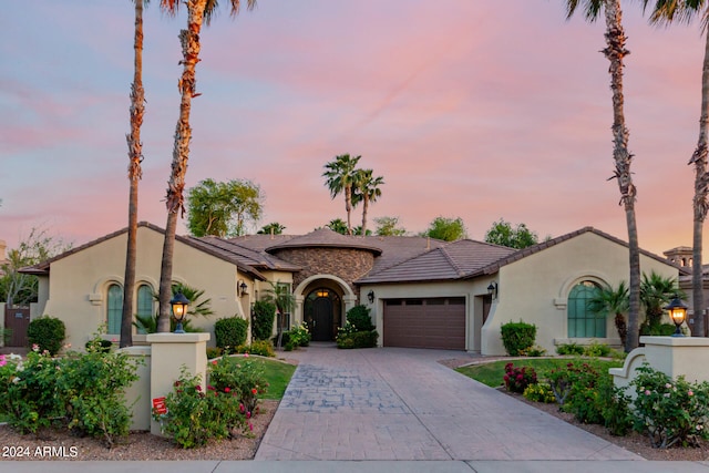 mediterranean / spanish home featuring a garage