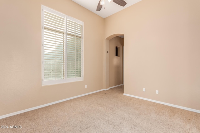 spare room featuring ceiling fan and carpet flooring