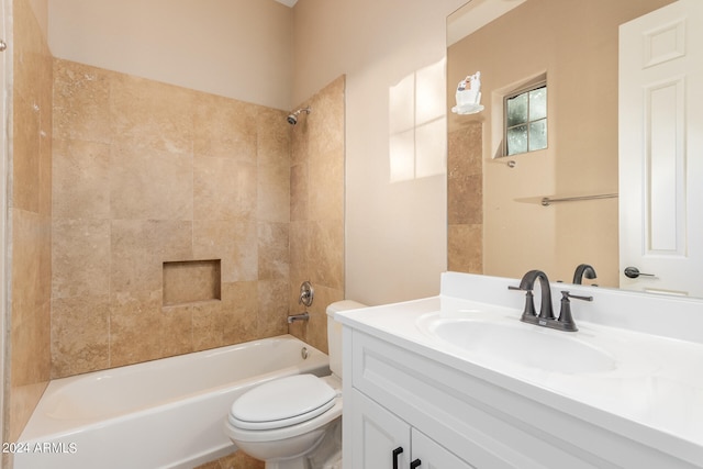 full bathroom with vanity with extensive cabinet space, tiled shower / bath, and toilet