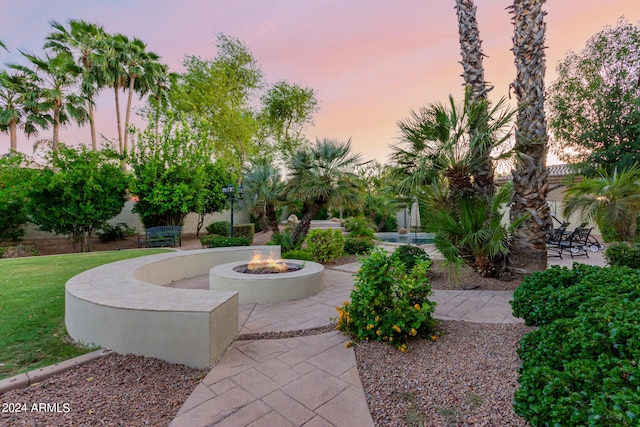 view of nearby features featuring a patio area, a fire pit, and a lawn