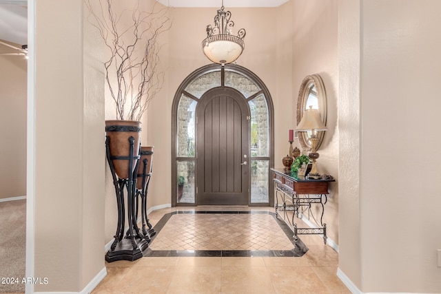 tiled entryway featuring ceiling fan