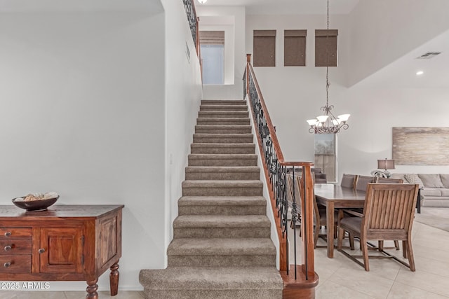 staircase with visible vents, a notable chandelier, recessed lighting, and tile patterned flooring