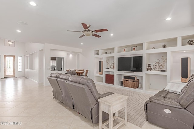 living room with a ceiling fan, recessed lighting, built in features, and light tile patterned floors