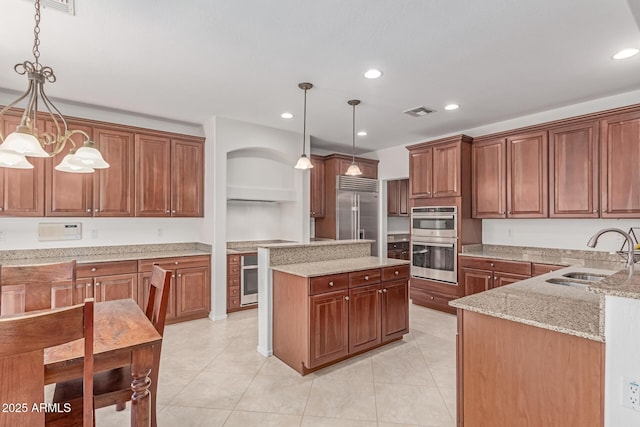 kitchen with a sink, light stone counters, stainless steel appliances, recessed lighting, and light tile patterned flooring