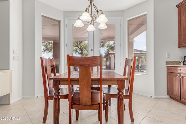 dining room with light tile patterned floors, plenty of natural light, and a chandelier