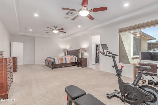 bedroom with baseboards, light carpet, a tray ceiling, and recessed lighting