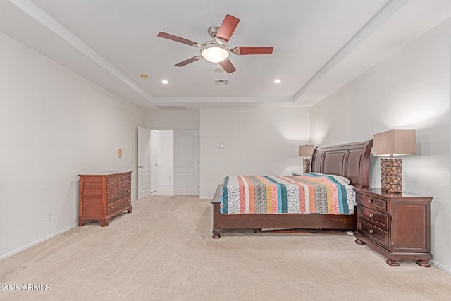 bedroom with recessed lighting, visible vents, light carpet, and a raised ceiling