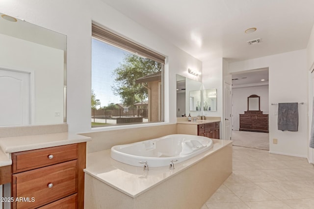 full bathroom featuring visible vents, tile patterned flooring, a garden tub, and vanity