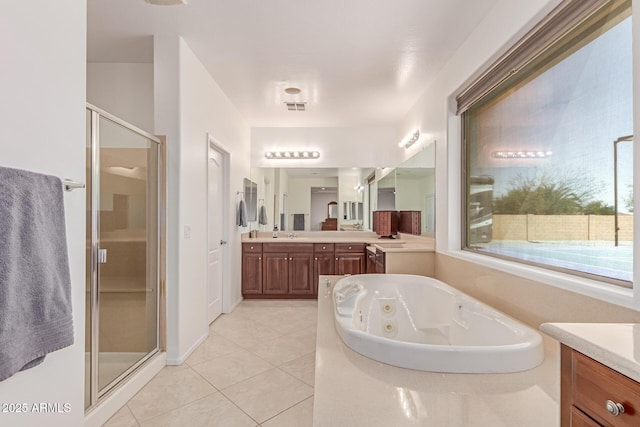 bathroom featuring visible vents, a shower stall, a jetted tub, and vanity