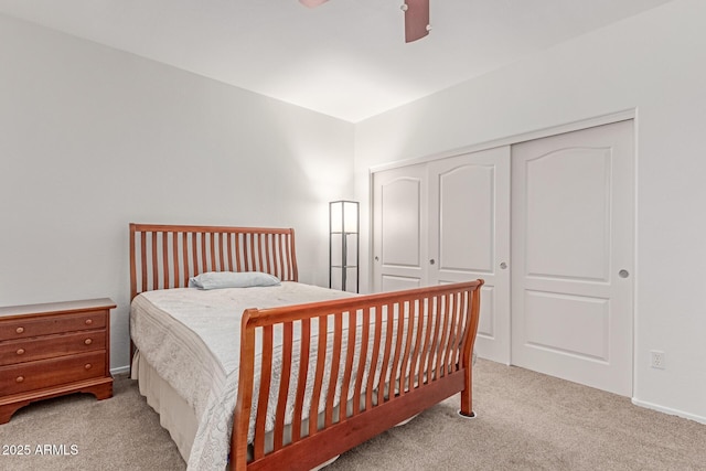 carpeted bedroom with a closet and ceiling fan