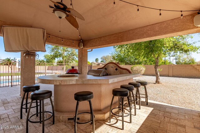 view of patio with a fenced backyard and outdoor wet bar