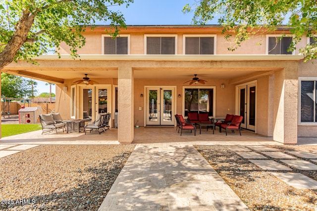 back of property featuring ceiling fan, a patio area, stucco siding, and french doors
