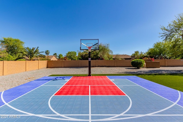 view of sport court with a fenced backyard and basketball court