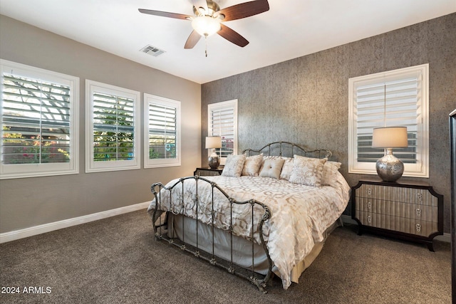 bedroom featuring ceiling fan and dark carpet