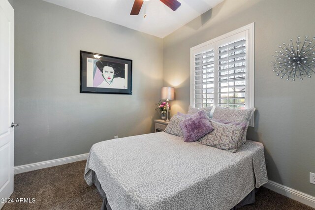 bedroom featuring ceiling fan and dark carpet