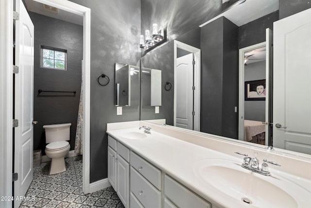 bathroom featuring tile patterned floors, vanity, and toilet