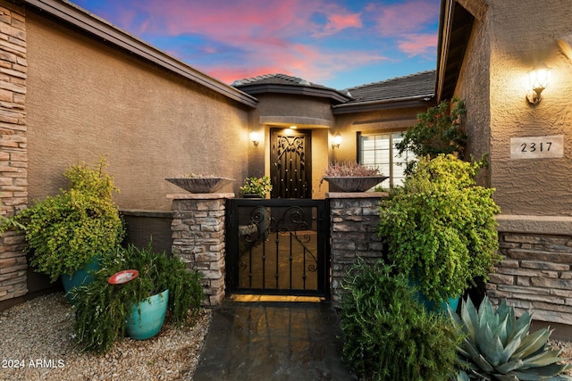 view of exterior entry at dusk