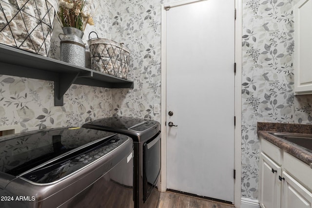 washroom with cabinets, dark wood-type flooring, and washing machine and clothes dryer