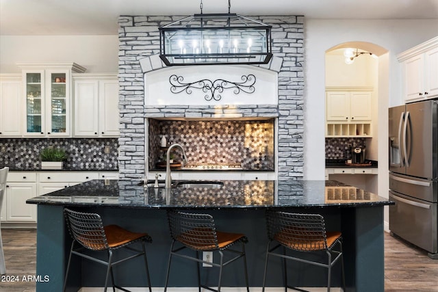 kitchen featuring stainless steel fridge with ice dispenser, backsplash, and dark hardwood / wood-style floors