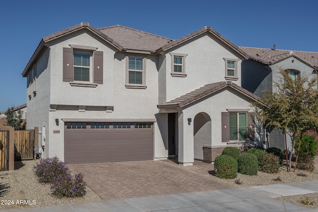 mediterranean / spanish house featuring a garage