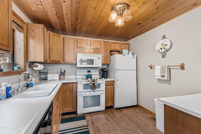 kitchen featuring wooden ceiling, a sink, light countertops, white appliances, and light wood-style floors