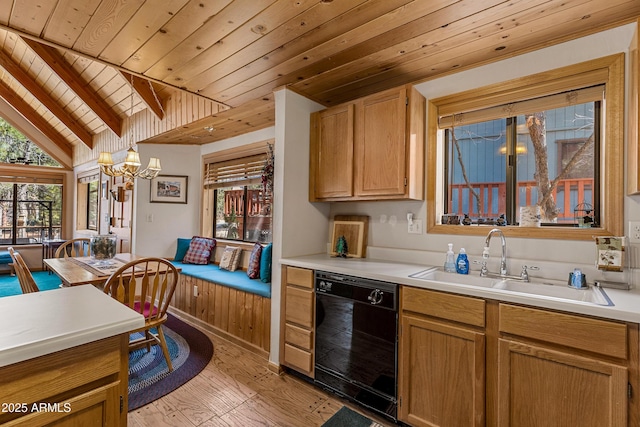 kitchen with light countertops, dishwasher, a sink, and a notable chandelier