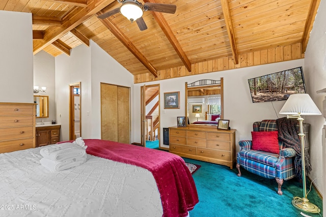 carpeted bedroom featuring wood ceiling, beamed ceiling, and ensuite bathroom