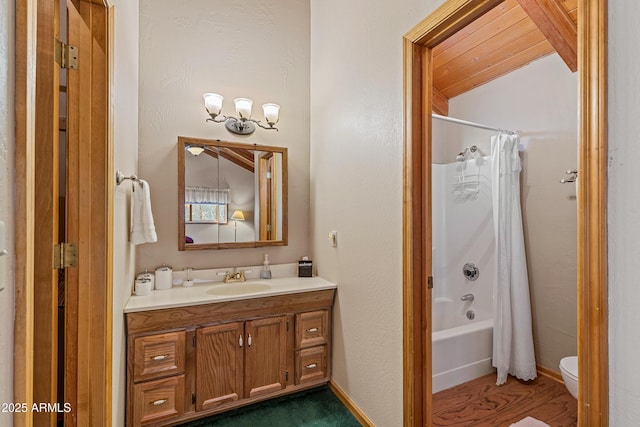 bathroom featuring baseboards, shower / bath combination with curtain, toilet, vanity, and lofted ceiling