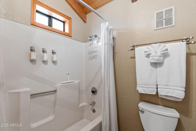 bathroom featuring toilet, shower / tub combo with curtain, and visible vents