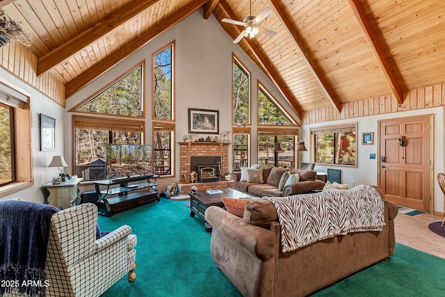 carpeted living room with beamed ceiling, ceiling fan, high vaulted ceiling, and wooden ceiling