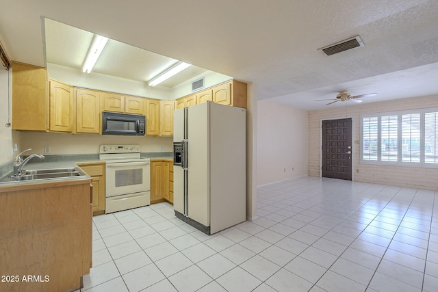 1530 E Loma Ln, Phoenix, AZ 85020 - kitchen with white appliances, light tile patterned floors, open floor plan, light brown cabinetry, and a ceiling fan