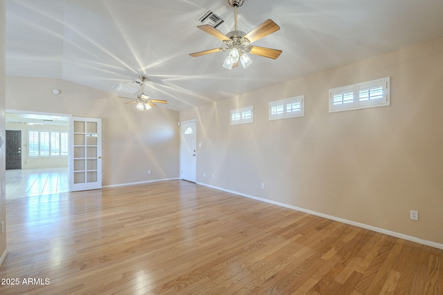 1530 E Loma Ln, Phoenix, AZ 85020 - empty room with healthy amount of natural light, lofted ceiling, light wood finished floors, ceiling fan, and french doors