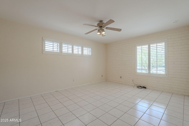 1530 E Loma Ln, Phoenix, AZ 85020 - unfurnished room featuring a ceiling fan, brick wall, and light tile patterned floors