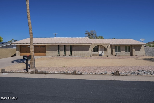 1530 E Loma Ln, Phoenix, AZ 85020 - view of front facade featuring concrete driveway, a tiled roof, and a garage