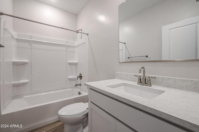 full bathroom with bathtub / shower combination, vanity, wood-type flooring, and toilet