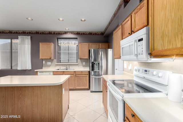 kitchen with sink, white appliances, and light tile patterned floors